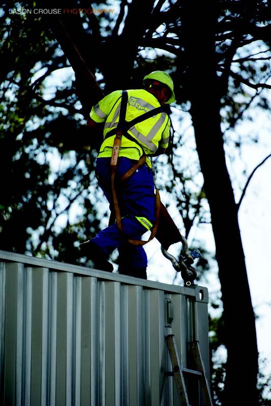 Rigger in fall-arrest harness