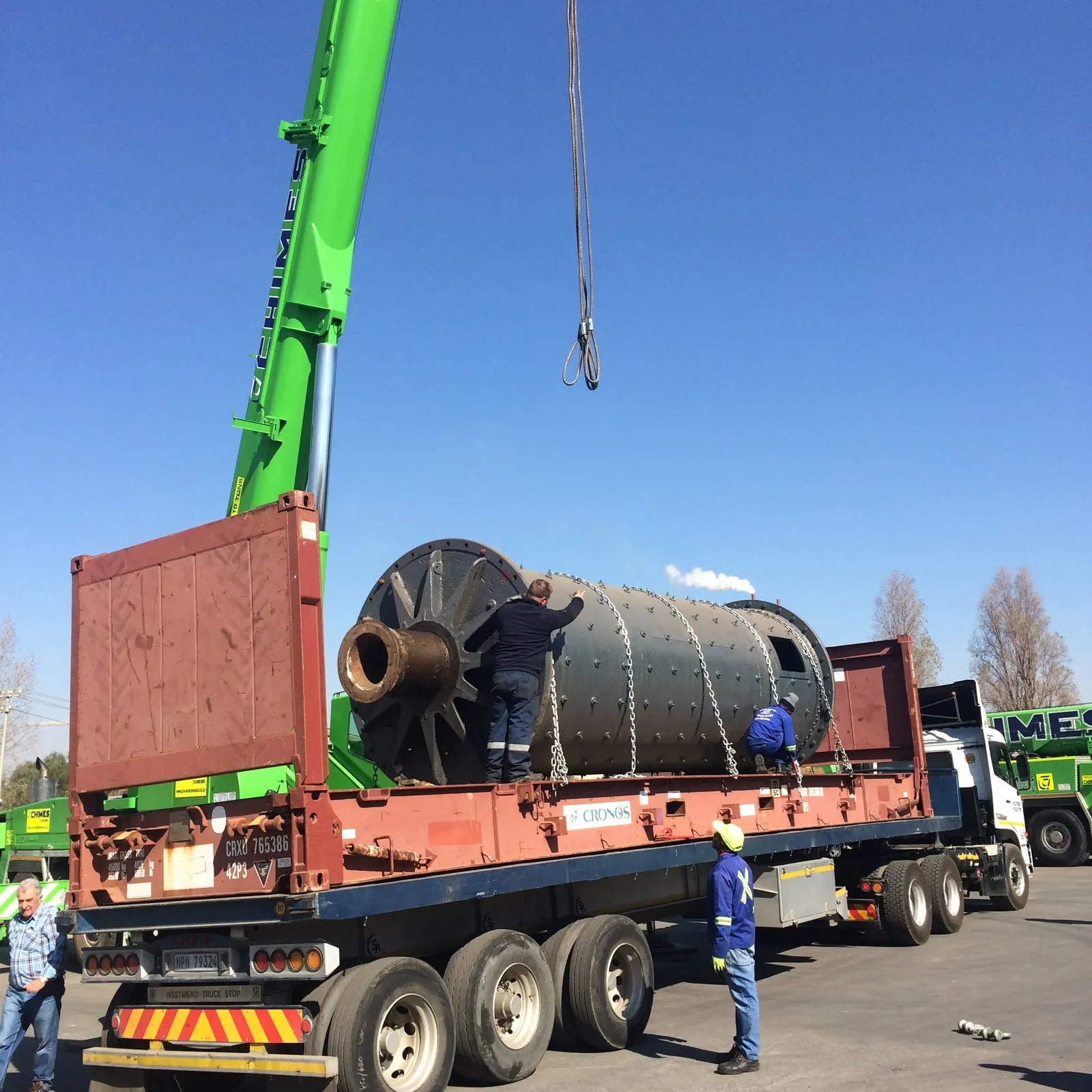 Crane installing plant equipment at an industrial facility
